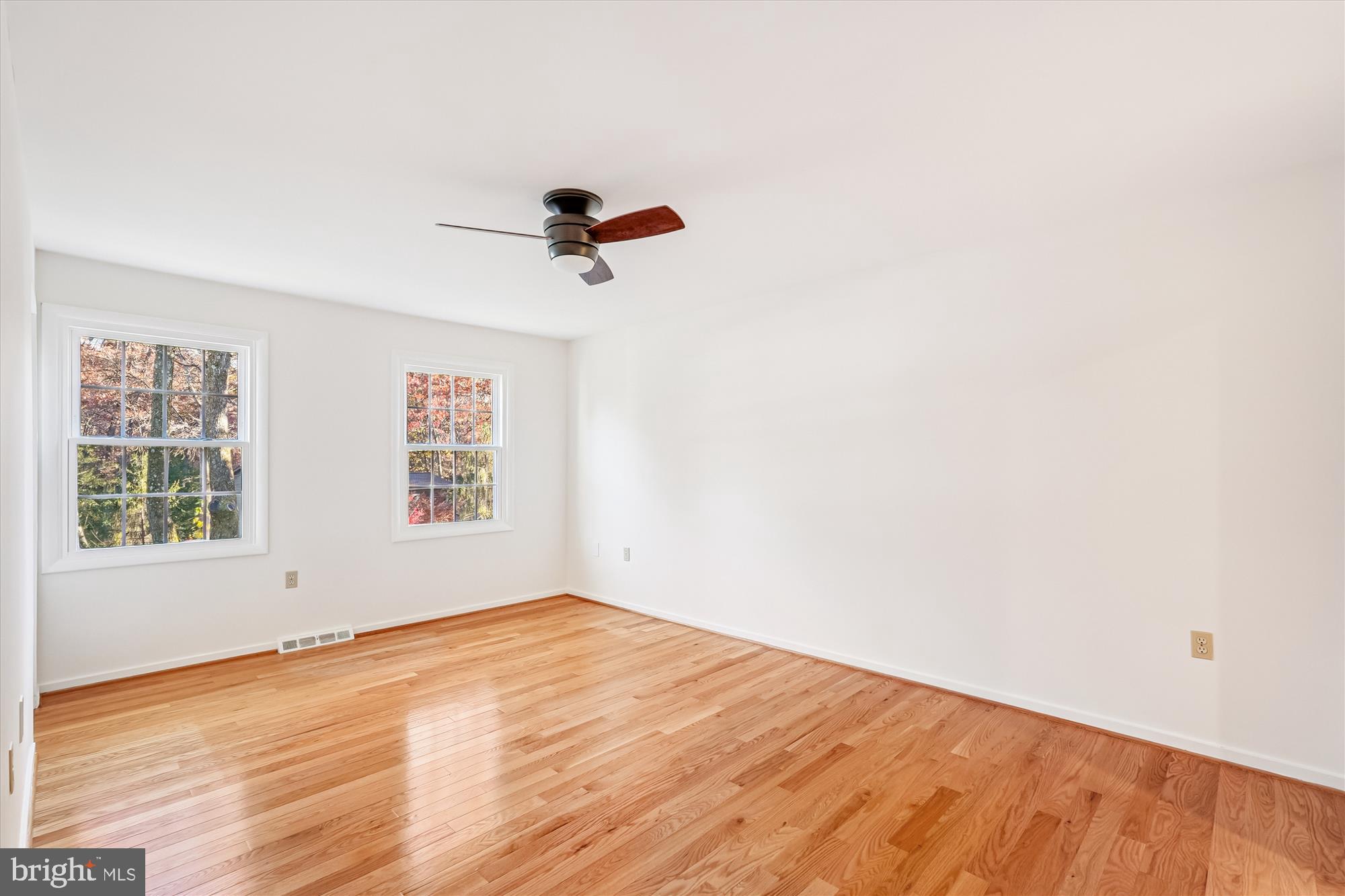 11410 Running Cedar Road Reston, VA 20191 - Photo 26 of 56 an empty room with wooden floor and windows