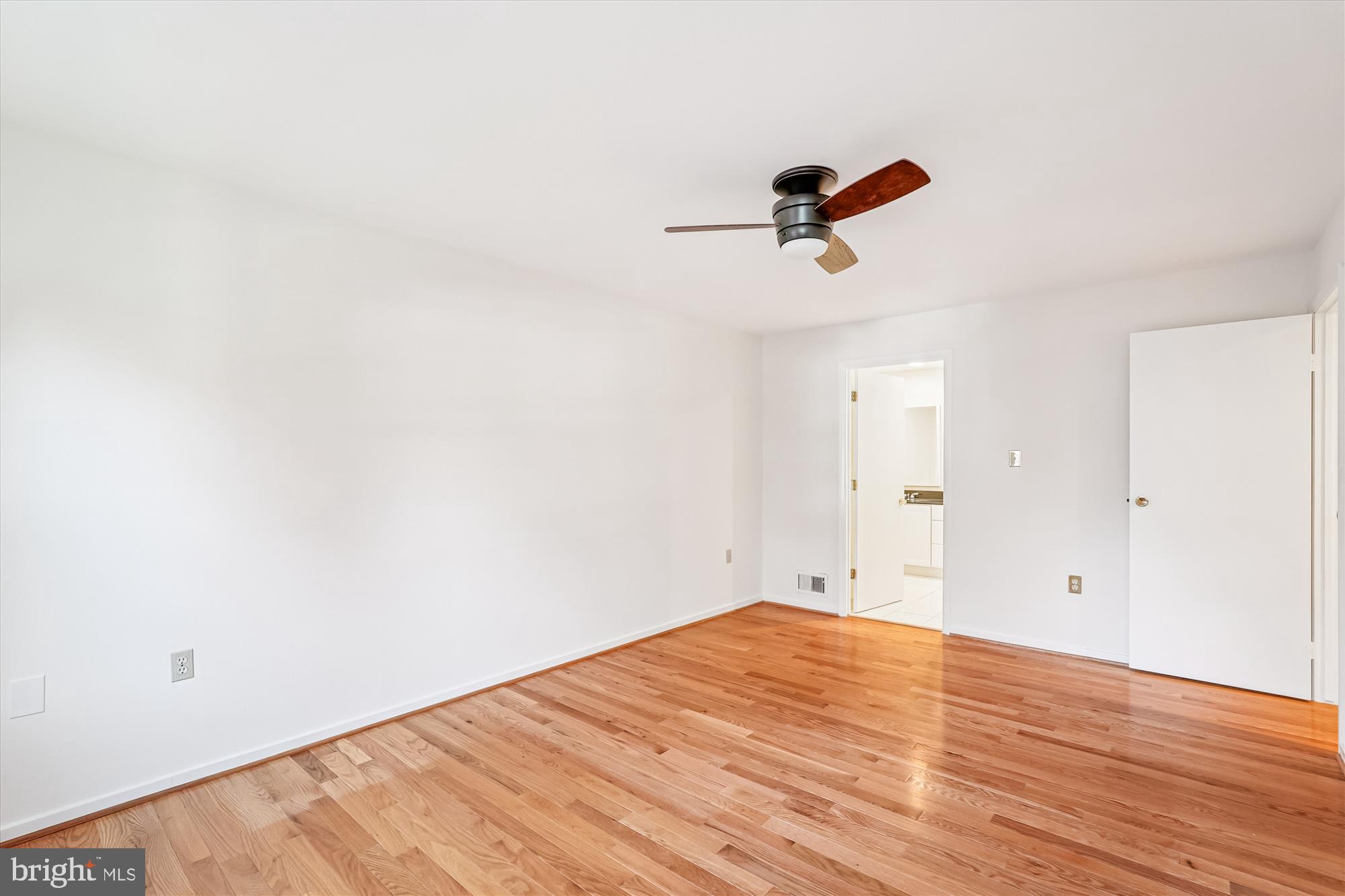 11410 Running Cedar Road Reston, VA 20191 - Photo 28 of 56 an empty room with wooden floor and windows