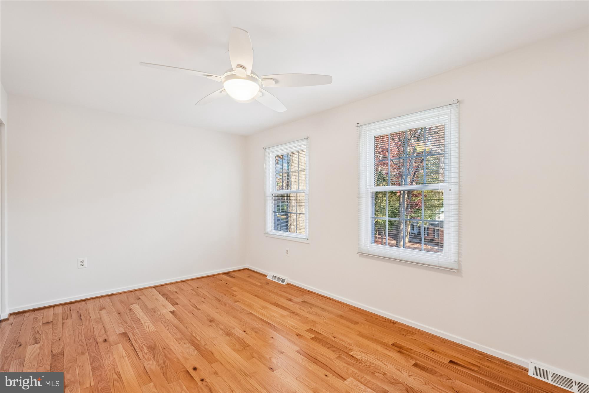 11410 Running Cedar Road Reston, VA 20191 - Photo 33 of 56 an empty room with wooden floor fan and windows
