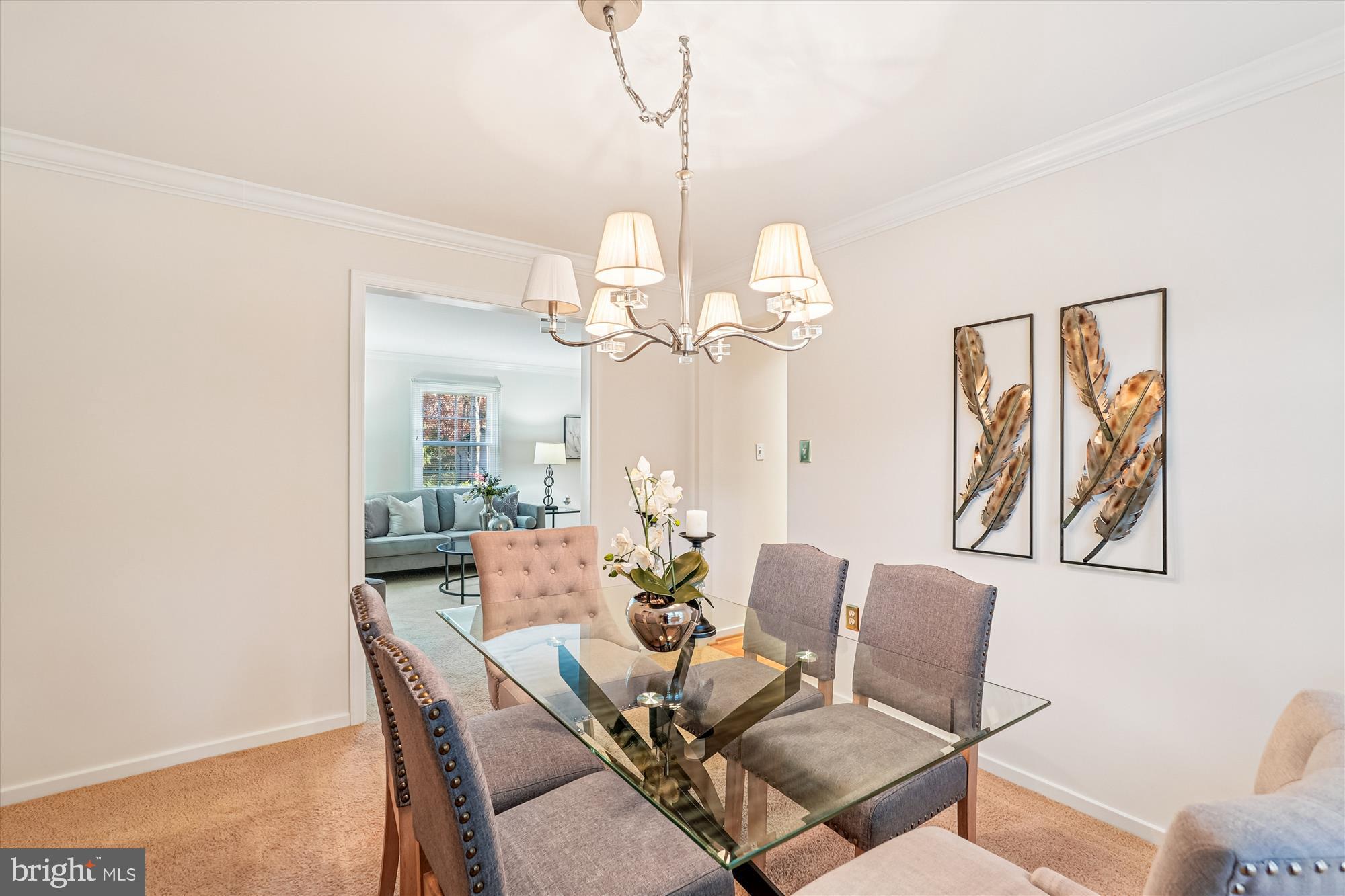 11410 Running Cedar Road Reston, VA 20191 - Photo 8 of 56 a dining room with wooden floor a chandelier a glass table and chairs