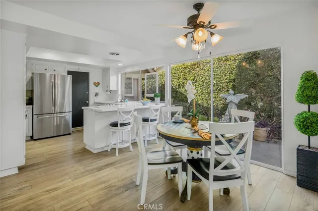 a dining room with furniture a chandelier and wooden floor