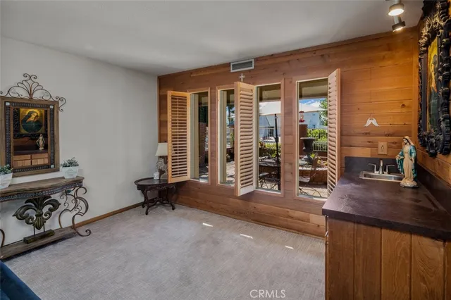 a living room with furniture and large windows