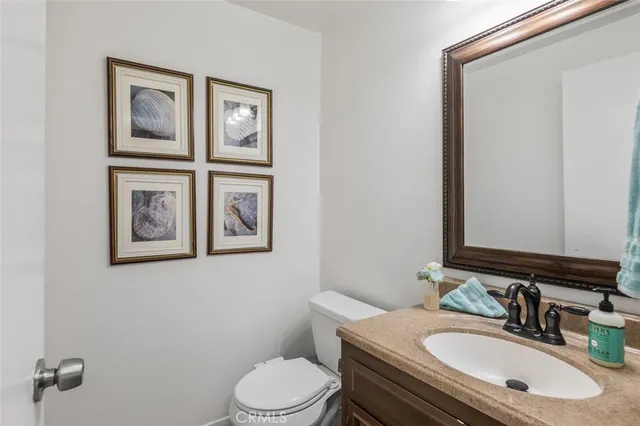 a front view of a house with a tree