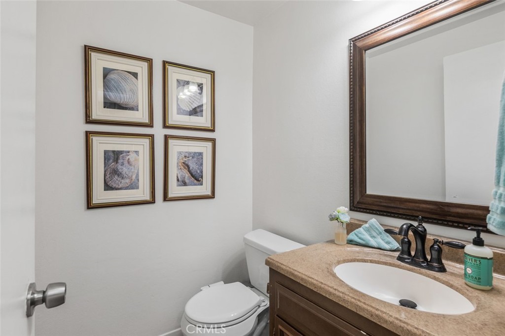 15232 Lille Circle Irvine, CA 92604 - Photo 29 of 54 a bathroom with a toilet a sink and mirror