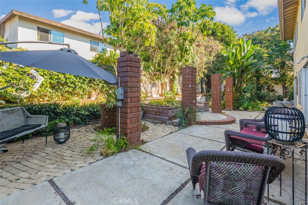 15232 Lille Circle Irvine, CA 92604 - Photo 31 of 54 a view of a patio with couches and table and chairs and potted plants