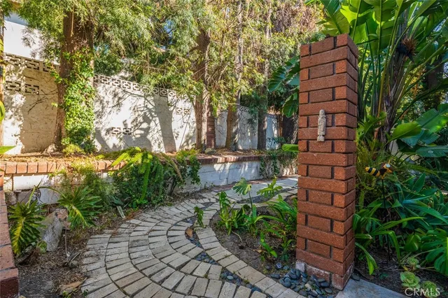 a view of a house with sitting area and garden