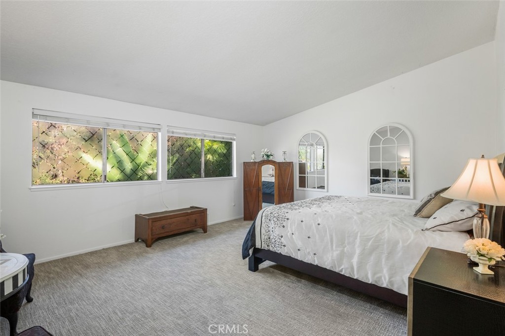 15232 Lille Circle Irvine, CA 92604 - Photo 38 of 54 a bedroom with a bed and large windows