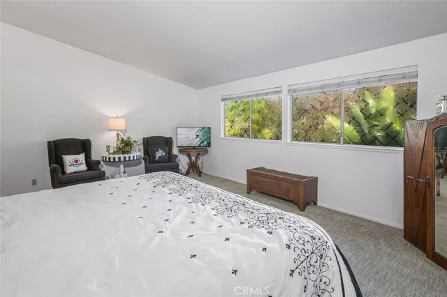 a bathroom with a granite countertop sink mirror and toilet