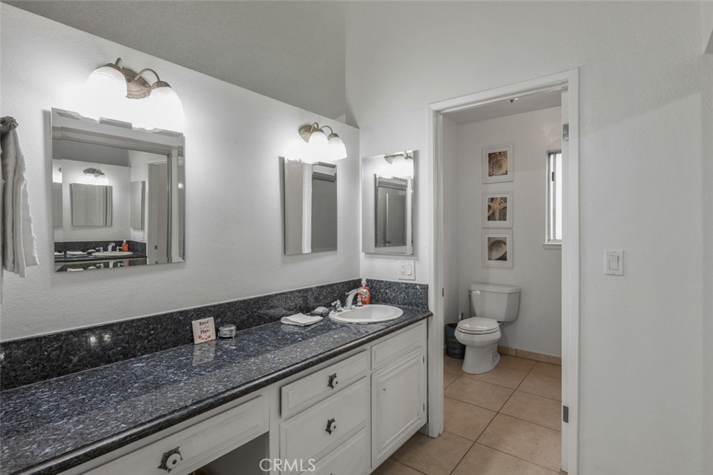 15232 Lille Circle Irvine, CA 92604 - Photo 40 of 54 a bathroom with a granite countertop sink mirror and toilet