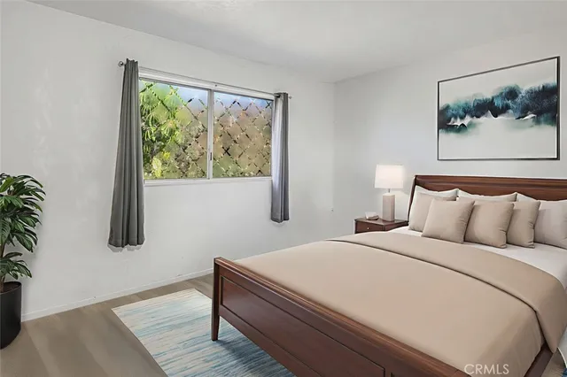 a bedroom with a bed and a painting on the wall