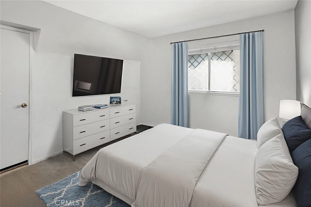 15232 Lille Circle Irvine, CA 92604 - Photo 45 of 54 a bedroom with a bed and a flat screen tv