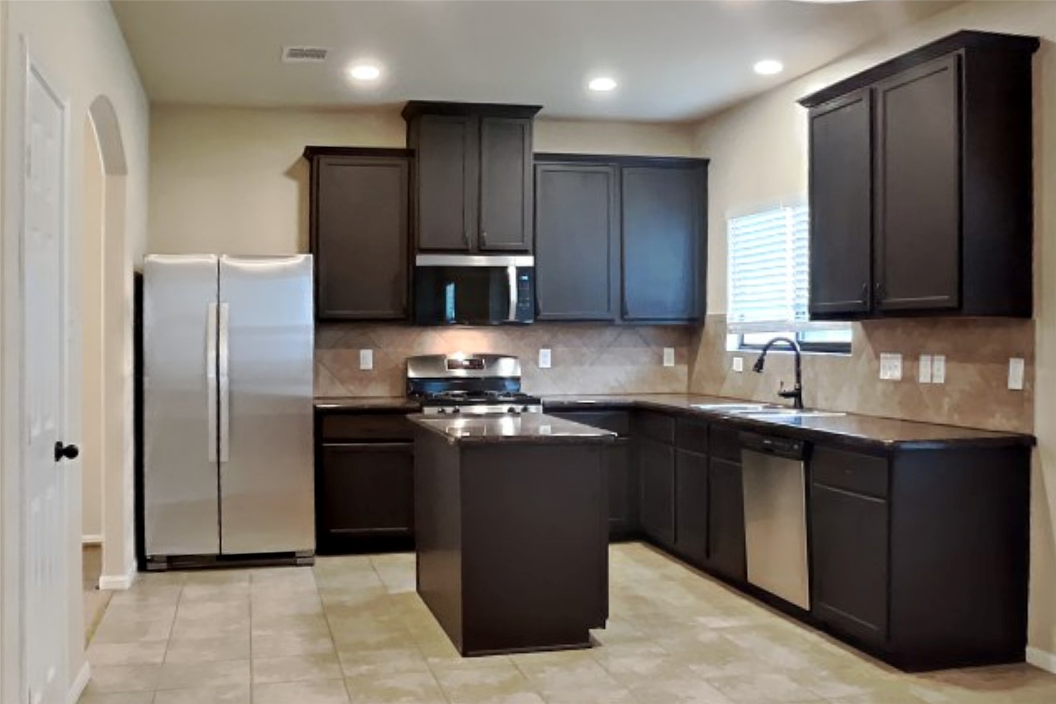 19715 Seabury Path Ct. Katy, TX 77449 - Photo 6 of 20 a modern kitchen with stainless steel appliances granite countertop a refrigerator a sink and wooden cabinets