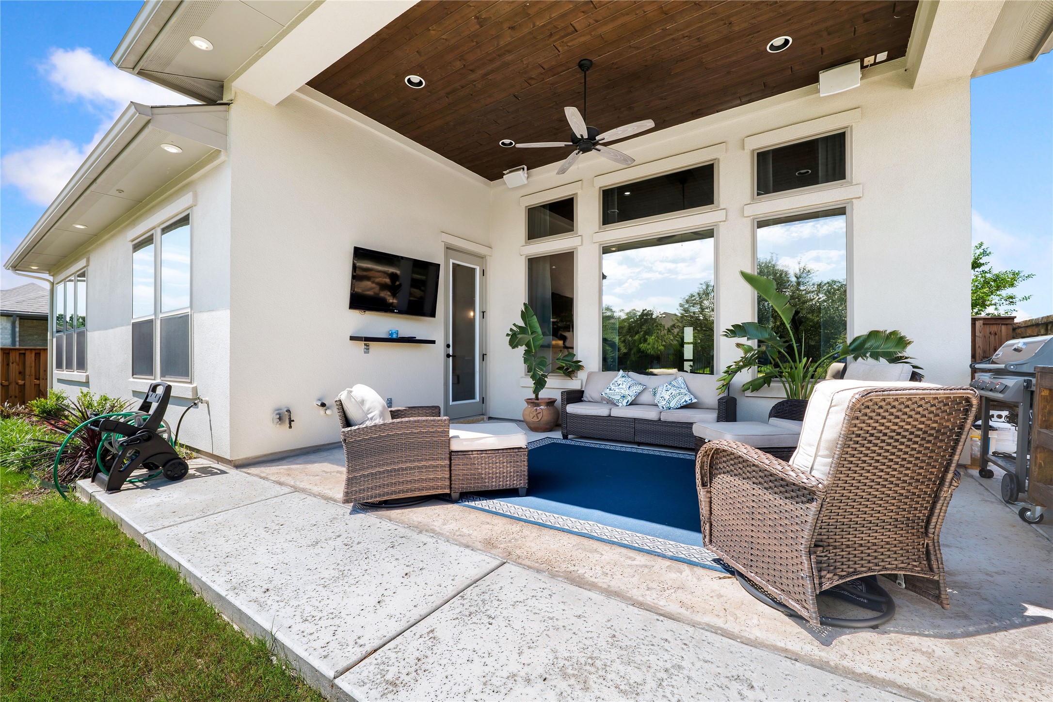 2408 Nate's Place Georgetown, TX 78633 - Photo 21 of 40 An inviting covered patio with a wooden ceiling and fan extends the living space outdoors.