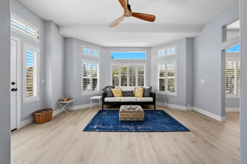 a living room with furniture and wooden floor