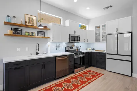 a kitchen with stainless steel appliances granite countertop a refrigerator sink and cabinets