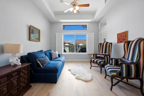 a living room with furniture a rug and a window
