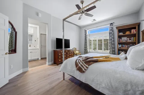 a bedroom with a bed and a chandelier