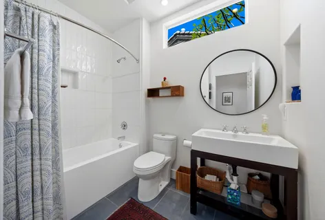 a bathroom with a sink a toilet and a mirror