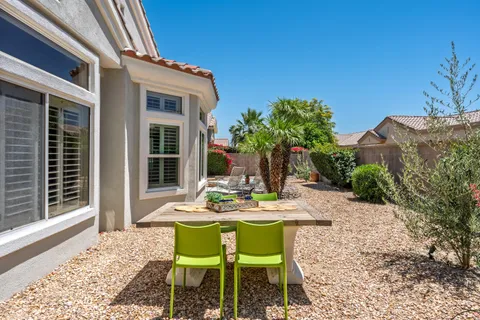 a view of a patio with table and chairs and potted plants