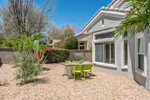a white bench sitting in front of a house