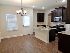 a kitchen with a sink appliances and cabinets