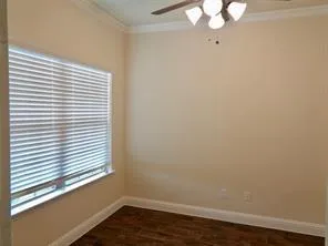 a view of a small space with wooden floor and a window