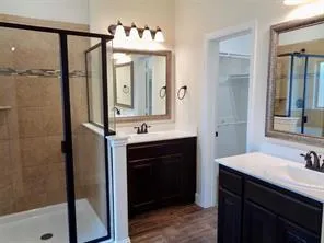 a bathroom with a sink vanity and a mirror