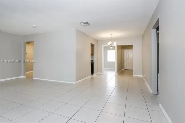 a view of hallway with a window and a kitchen
