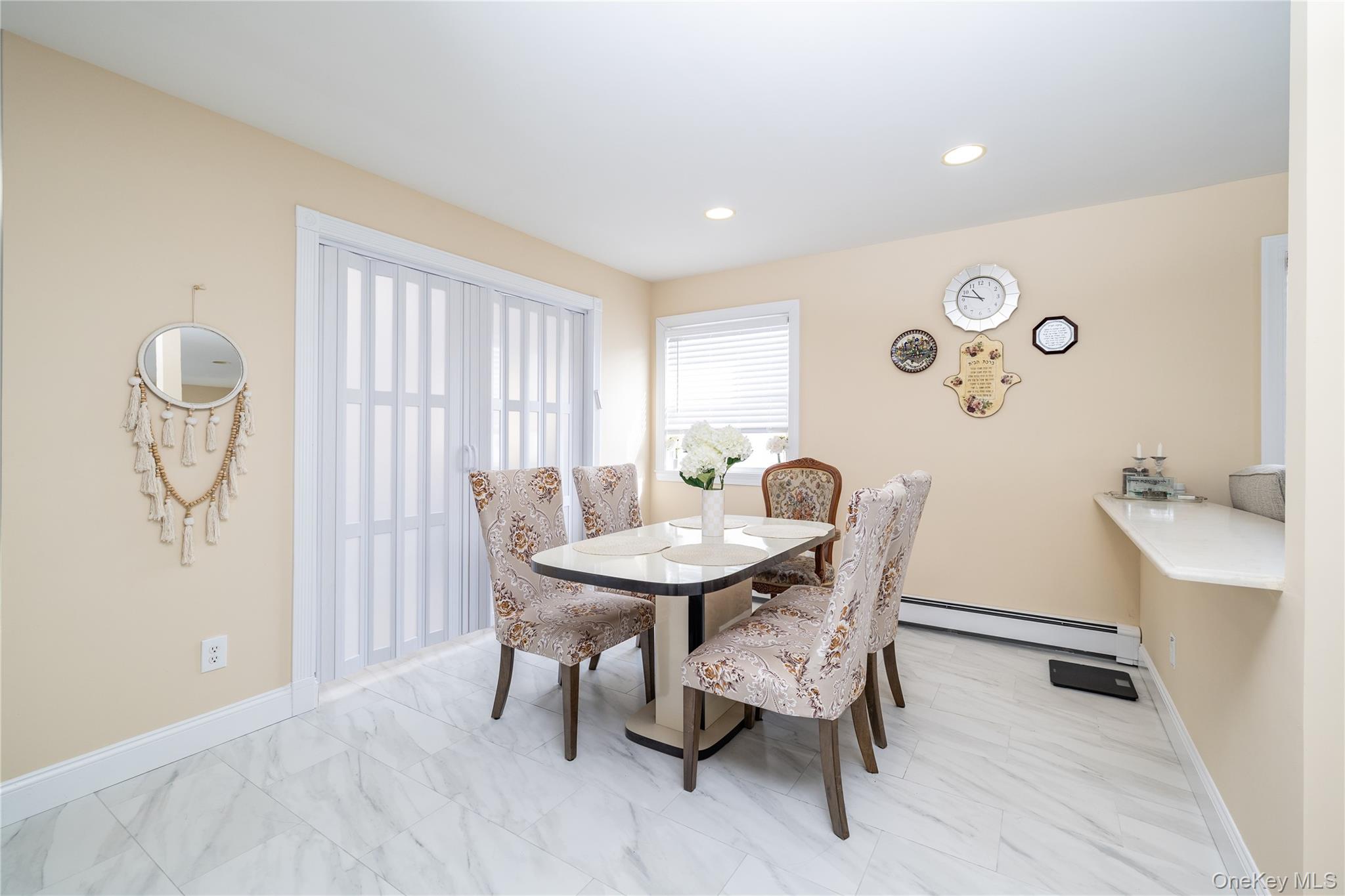 458 East Pine Street Long Beach, NY 11561 - Photo 10 of 26 a view of a dining room with furniture and a window
