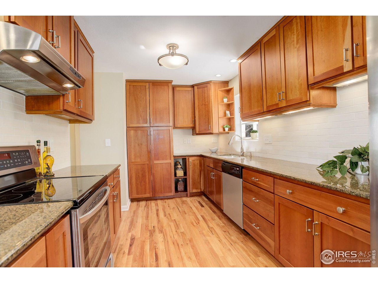 4361 Butler Circle Boulder, CO 80305 - Photo 12 of 39 a kitchen with wooden cabinets and sink