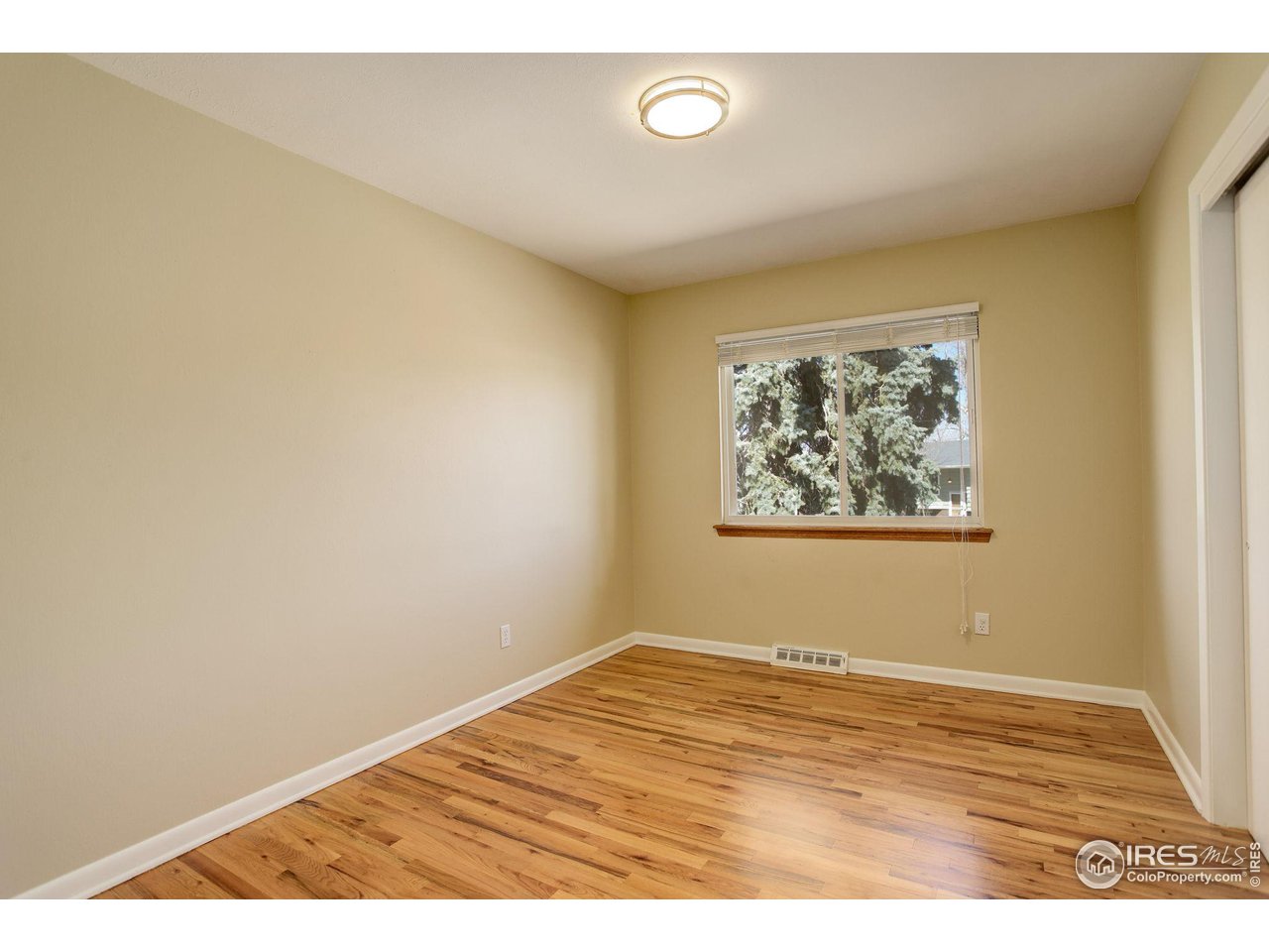 4361 Butler Circle Boulder, CO 80305 - Photo 20 of 39 an empty room with wooden floor and window
