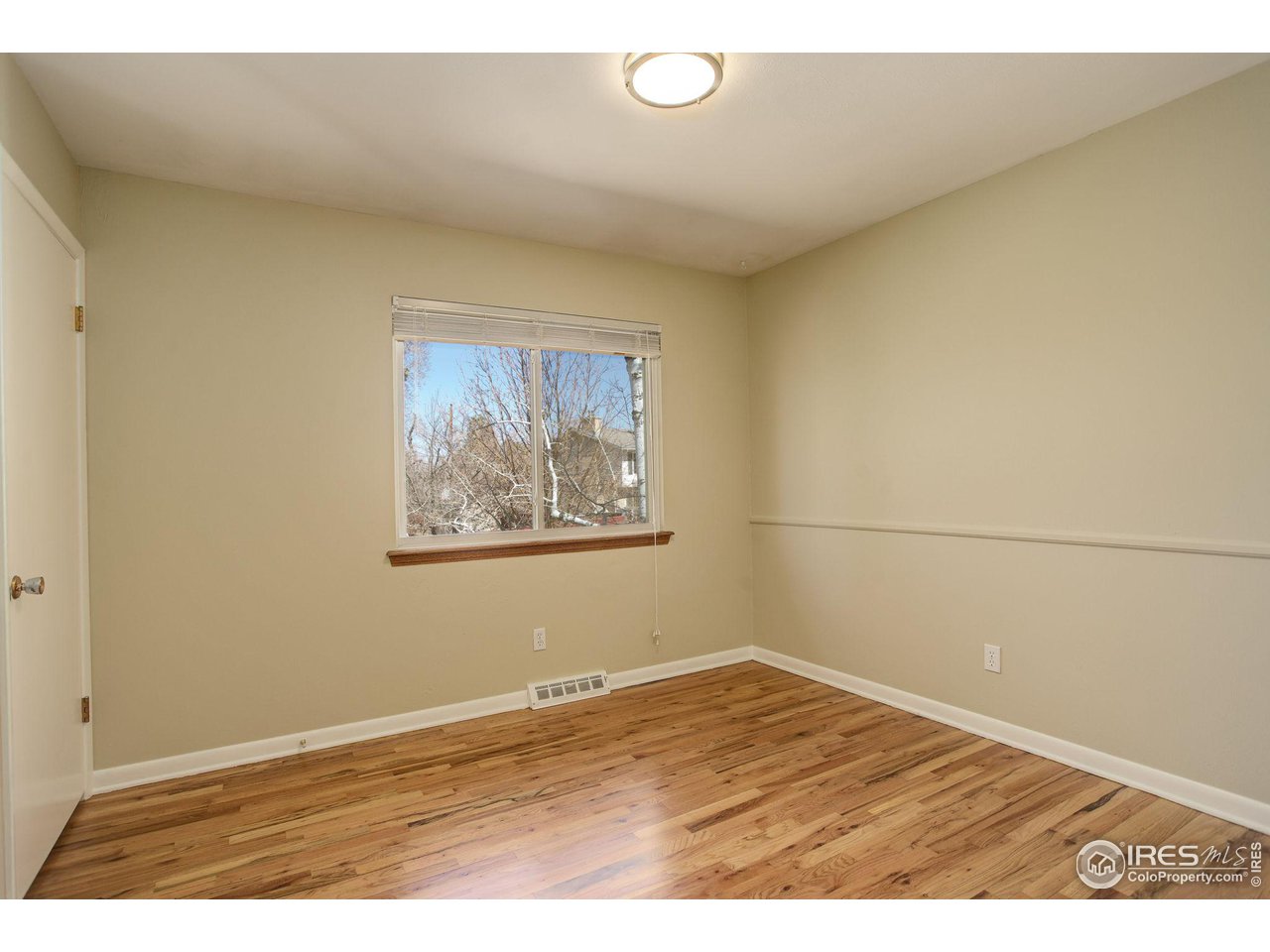 4361 Butler Circle Boulder, CO 80305 - Photo 21 of 39 an empty room with wooden floor and fan