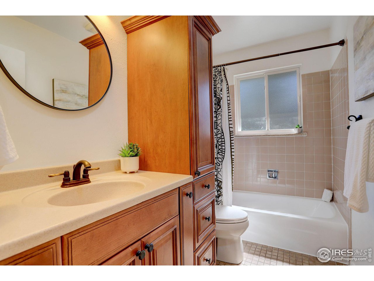 4361 Butler Circle Boulder, CO 80305 - Photo 22 of 39 a bathroom with a sink a toilet and a mirror