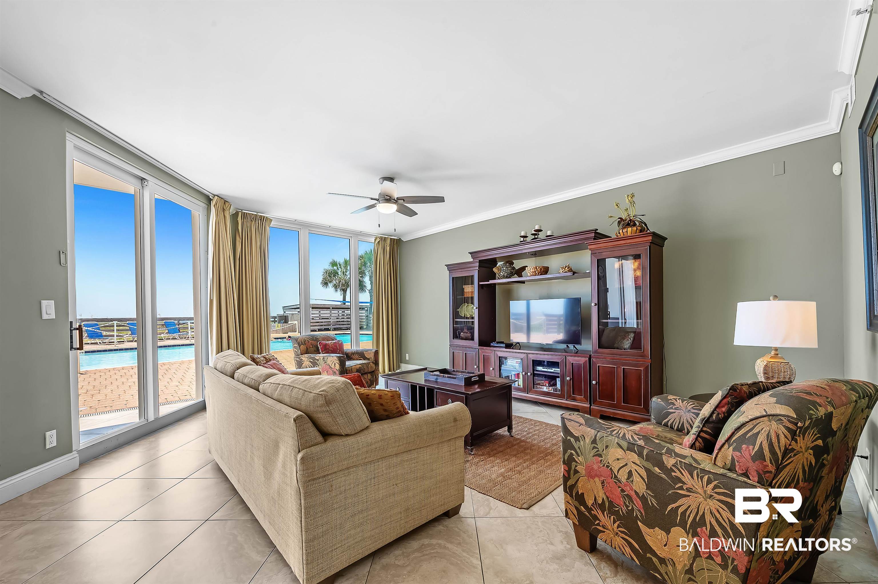 16287 Perdido Key Drive, Unit 105 Pensacola, FL 32507 - Photo 8 of 66 Living area with expansive sliding glass doors and transom windows