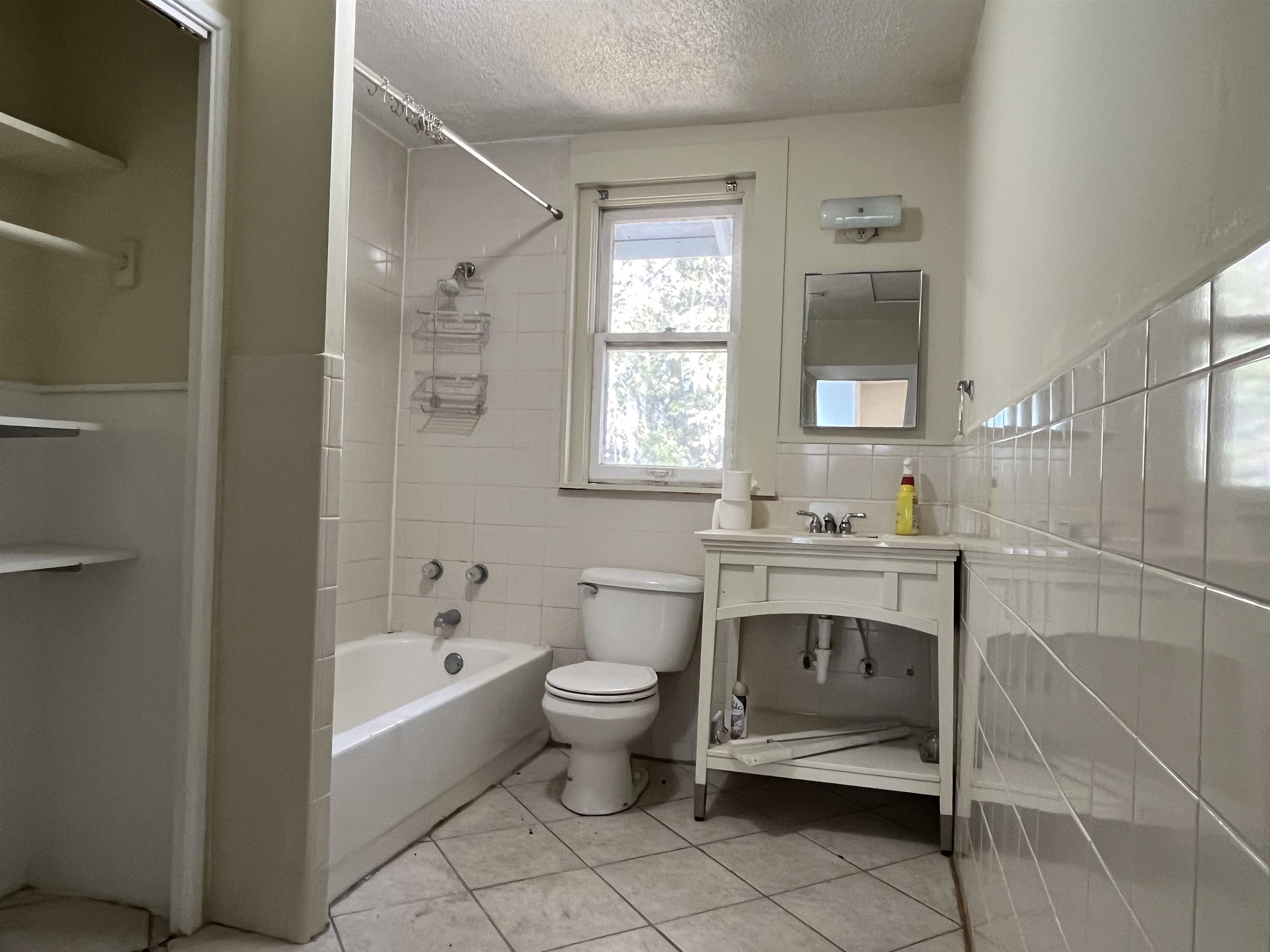 114 Bridge Street, Unit B St. Augustine, FL 32084 - Photo 12 of 14 a bathroom with a sink toilet and shower
