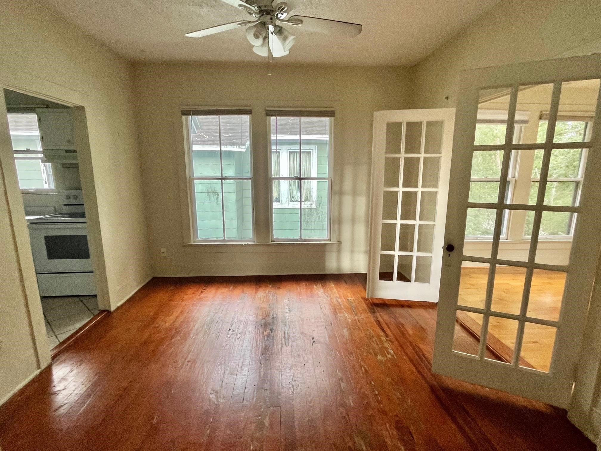114 Bridge Street, Unit B St. Augustine, FL 32084 - Photo 2 of 14 a view of an empty room with a window and wooden floor