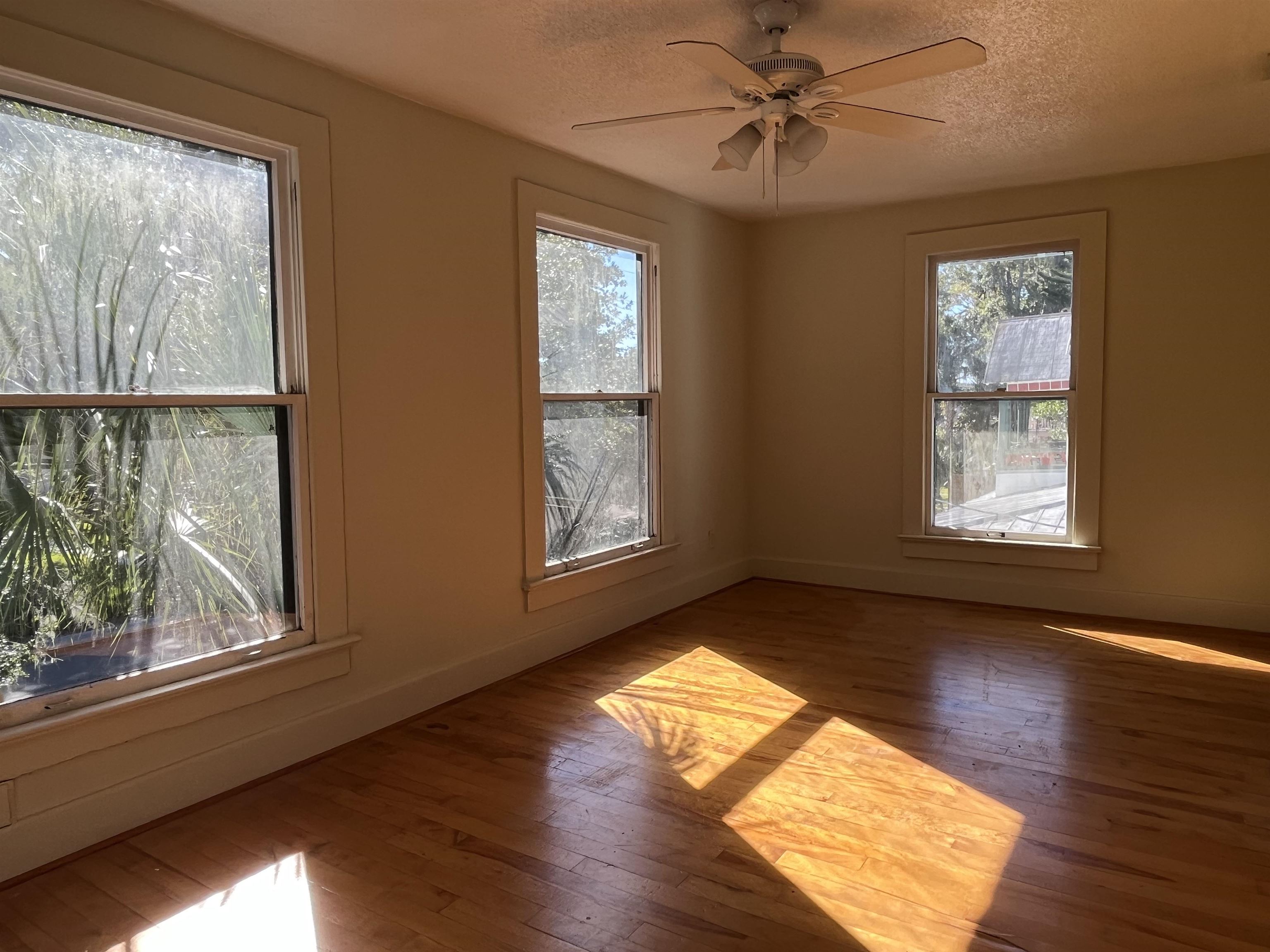 114 Bridge Street, Unit B St. Augustine, FL 32084 - Photo 4 of 14 a view of empty room with wooden floor and fan