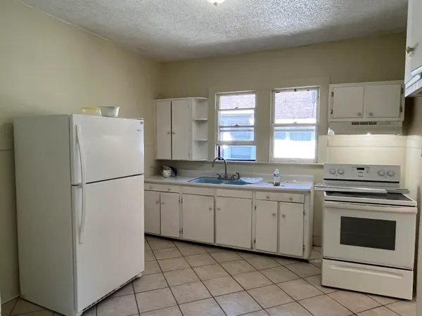a white refrigerator freezer sitting inside of a kitchen