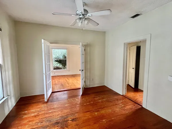 wooden floor in an empty room with a window
