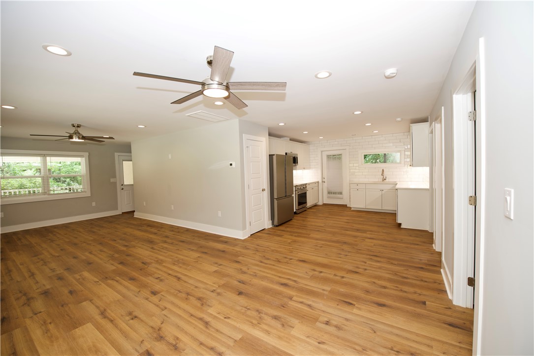 317 Pendleton Road Clemson, SC 29631 - Photo 11 of 36 An open-concept living space with lustrous hardwood-style flooring flows seamlessly into a contemporary kitchen.