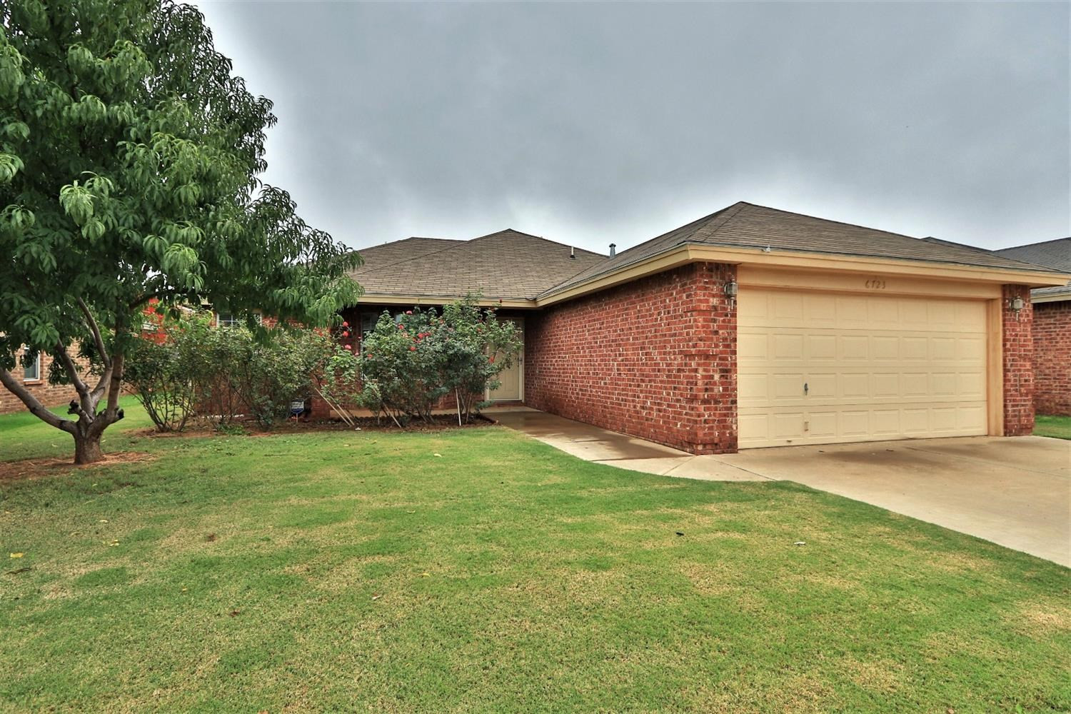 6723 8th Street Lubbock, TX 79416 - Photo 2 of 9 a front view of house with yard and trees