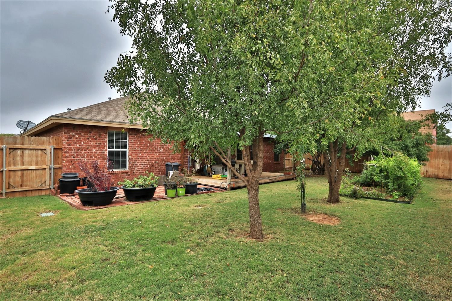 6723 8th Street Lubbock, TX 79416 - Photo 5 of 9 a front view of a house with a garden