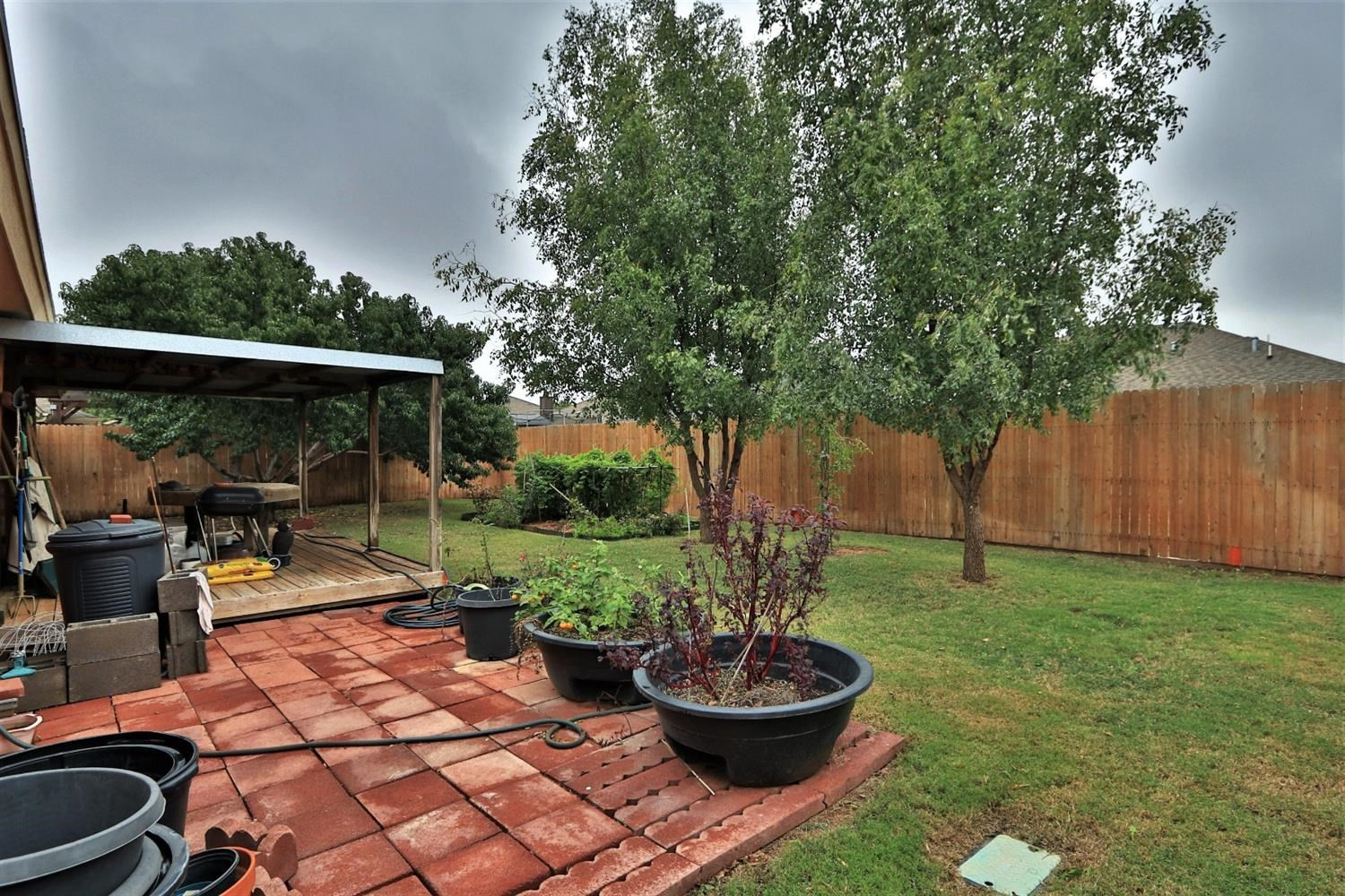 6723 8th Street Lubbock, TX 79416 - Photo 6 of 9 a view of a backyard with plants and chairs