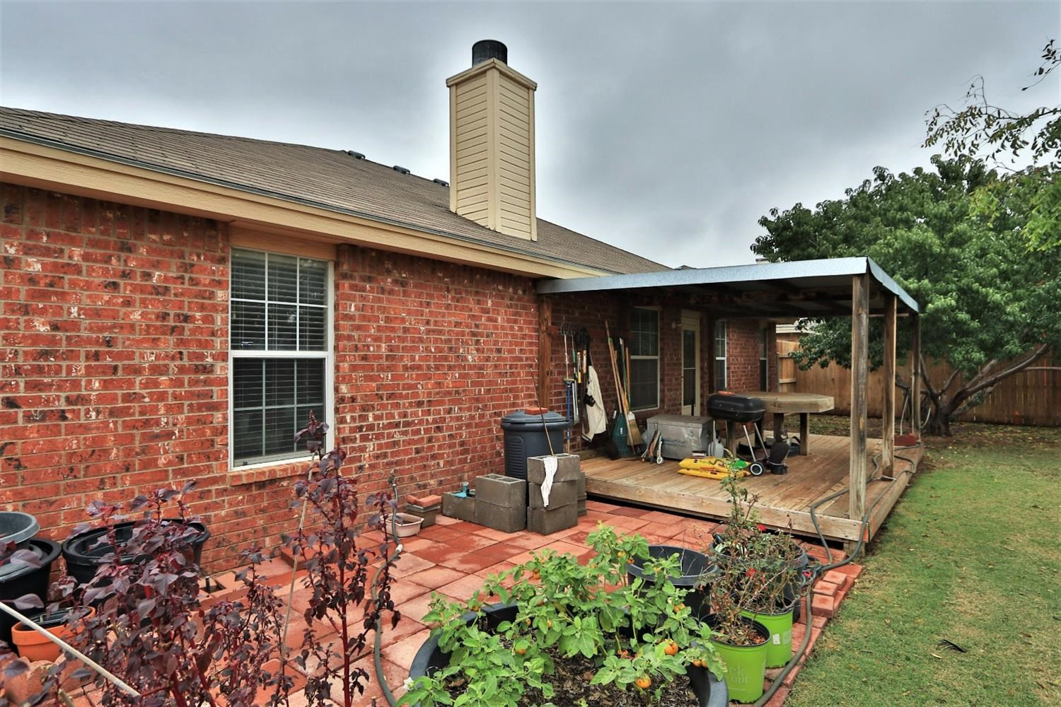 6723 8th Street Lubbock, TX 79416 - Photo 7 of 9 a front view of a house with sitting area and garden