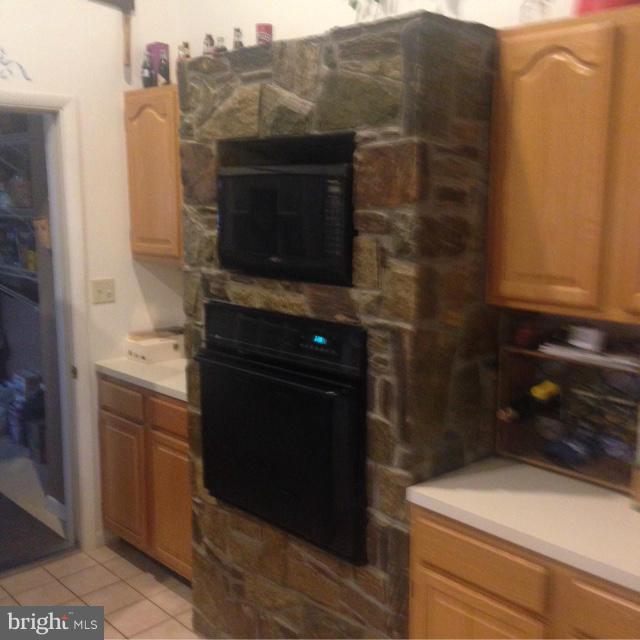 11833 Cash Smith Road Keymar, MD 21757 - Photo 11 of 16 a kitchen with a sink and a microwave