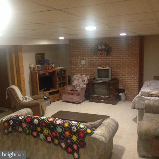 11833 Cash Smith Road Keymar, MD 21757 - Photo 13 of 16 a living room with furniture a flat screen tv and a fireplace
