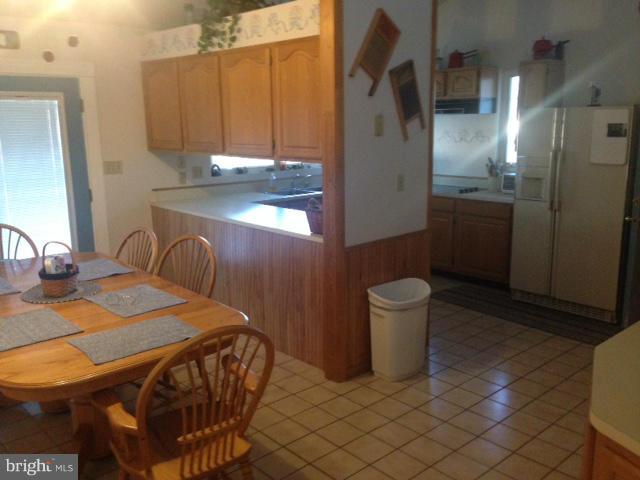 11833 Cash Smith Road Keymar, MD 21757 - Photo 6 of 16 a kitchen with a sink a refrigerator and cabinets