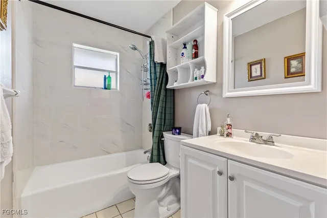 a bathroom with a sink mirror vanity and toilet