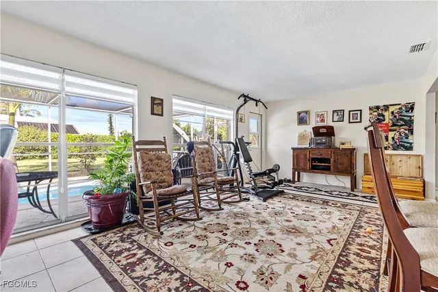 a view of a livingroom with workspace and a window