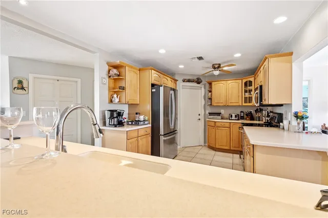 a large kitchen with stainless steel appliances lots of counter space and a sink